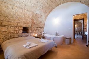 Postel nebo postele na pokoji v ubytování Agriturismo Le Fornelle
