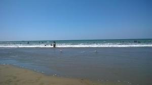 a group of people in the water at the beach at Hotel Puerto Gaviota in Tonsupa