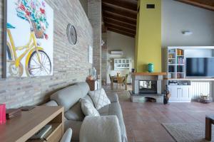 a living room with a couch and a fireplace at Luxury villa close to beach, mountain and golf! in Alzira