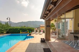 a swimming pool next to a house with a patio at Luxury villa close to beach, mountain and golf! in Alzira