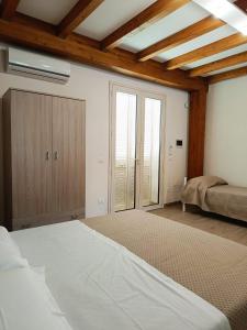 a bedroom with a large bed and a window at IL Casale di Petrosino in Petrosino