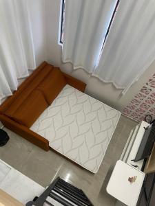 a small bed in a room with a window at Brisa - Praia da Pipa in Pipa