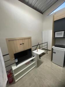 a living room with a flat screen tv and a table at Brisa - Praia da Pipa in Pipa