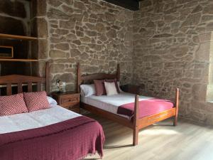 Postel nebo postele na pokoji v ubytování Casa Grande de Cristosende