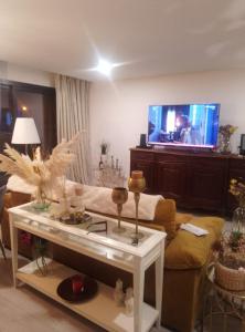 a living room with a couch and a tv at Rio da valeta in Arcos de Valdevez