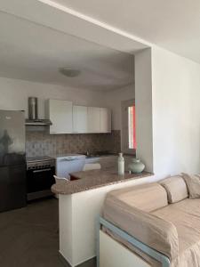 a kitchen with white cabinets and a counter top at Rural Apartment 44 in Alghero