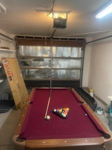 a pool table with a cue and balls on it at Freeman Enterprises LLC in Las Vegas