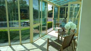 a screened in porch with a table and chairs at Smart Value Premium Alpine Stay Strictly Smoke, Vape & Pet Free in Methven