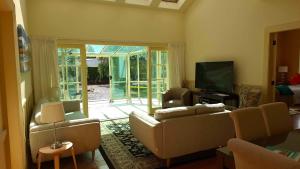 a living room with a couch and a tv at Smart Value Premium Alpine Stay Strictly Smoke, Vape & Pet Free in Methven
