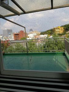 a balcony with a view of a city at Namsan Ville in Seoul