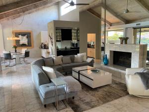 a living room with a couch and a fireplace at Cloud Nine in Rancho Mirage