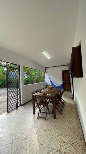a dining room with a wooden table and chairs at Casa na Serra de Martins in Martins
