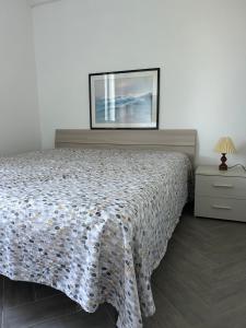 a bedroom with a bed and a picture on the wall at Rural Apartment 44 in Alghero