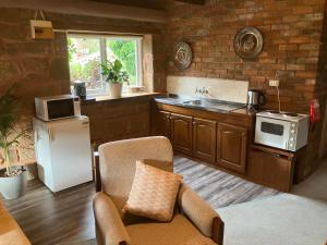 a kitchen with a white refrigerator and a counter top at Rose Cottage in Hamilton