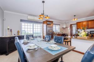 a kitchen and dining room with a table and chairs at La Casita Felizola- Charming Coastal Escape in São Pedro