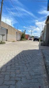 a cobblestone street with a car parked on it at Casa da Marília in Porto Seguro