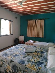 Ένα ή περισσότερα κρεβάτια σε δωμάτιο στο Pousada Maruru