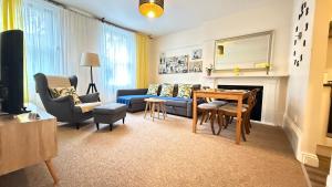 a living room with a blue couch and a table at Central Located One Bedroom Apt in Bristol