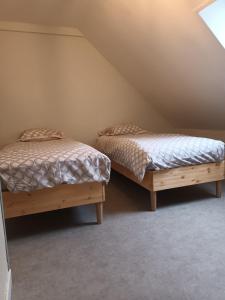 two twin beds in a room with a attic at Le 289 Audruicq in Audruicq