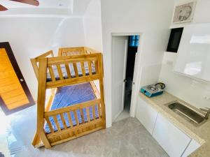 a kitchen with a wooden ladder in a room at Casa Mia Apartments in Villasis