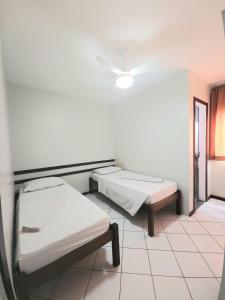 a hospital room with two beds and a ceiling at Pousada Central in Feira de Santana
