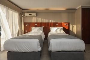 Postel nebo postele na pokoji v ubytování Mahia hotel Reñaca