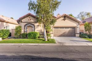 a house with a tree and a garage at The Greens, Golf, Pool & Arcade by Coachella in Indio