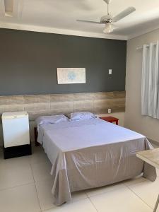 a bedroom with a large bed with a ceiling at atalaia mar I in Aracaju
