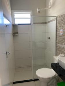 a bathroom with a shower with a toilet and a sink at atalaia mar I in Aracaju