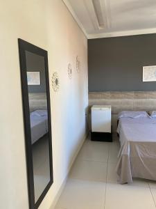 a mirror in a room with two beds at atalaia mar I in Aracaju