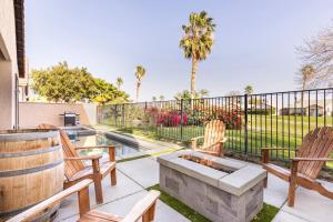 a patio with two chairs and a fire pit at The Greens, Golf, Pool & Arcade by Coachella in Indio