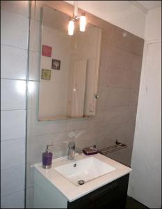 a bathroom with a white sink and a mirror at 2 Alpes Les Bleuets in Les Deux Alpes