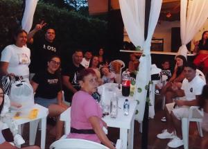 a group of people sitting at tables at a party at hosteria y camping piedras verdes in Sopetrán
