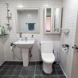 a bathroom with a toilet and a sink and mirror at Como House in Daegu +8 photos
