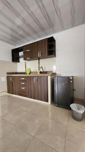 a kitchen with wooden cabinets and a black refrigerator at Apartamento Independiente 2 habitaciones Centro Comercial Campanario in Popayan