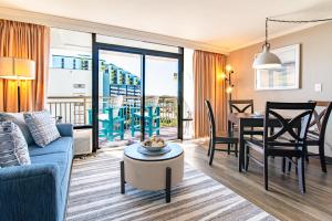 a living room with a couch and a table and a dining room at Cool Coast Ocean View Resort Studio in Myrtle Beach +42 photos