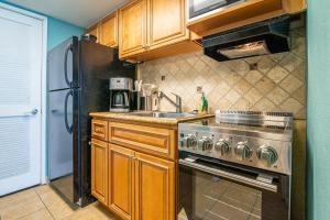 a kitchen with a stainless steel stove and a sink at Ocean Front Escape with Lazy River in Myrtle Beach