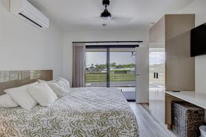 a bedroom with a large bed and a sliding glass door at Maisie in Mission Beach +32 photos
