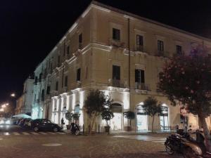 a large building on a city street at night at B&B CARAVAGGIO SIRACUSA 200 Metres from Ortigia in Siracusa