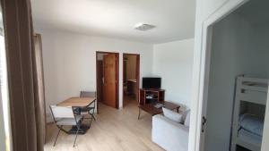 a living room with a couch and a table at Appartement Vina in Anse des Flamands