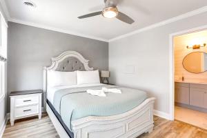 a bedroom with a white bed with a ceiling fan at Walk 2 Beach, Boardwalk & All Broadway Attractions in Myrtle Beach