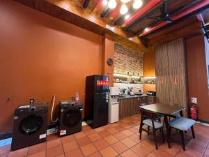 a kitchen with a washer and dryer and a table at Hotel Ban Sheng Teik in Ipoh