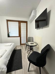 a bedroom with a bed and a chair and a table at Star in Varna City