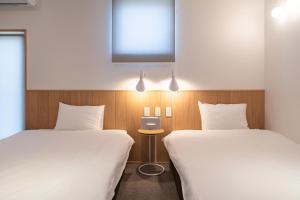 Postel nebo postele na pokoji v ubytování Beach SPA TSUDA 0 Cero棟