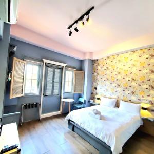 a bedroom with a bed and a yellow wall at Central Cheese Bon Guest House花蓮市中心-起司旅電梯民宿 in Hualien City