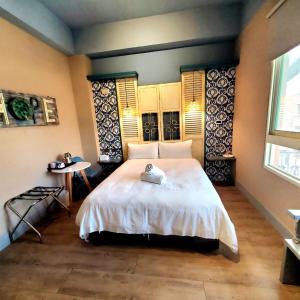 Ένα ή περισσότερα κρεβάτια σε δωμάτιο στο 花蓮市中心-起司旅電梯民宿