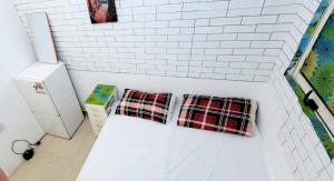 two plaid pillows sitting on a white brick wall at Room , Partition room , Partition , Master room in Dubai