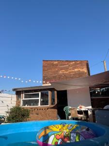 a pool with a painting on it in front of a house at cabaña art fuerte aguayo in Valparaíso