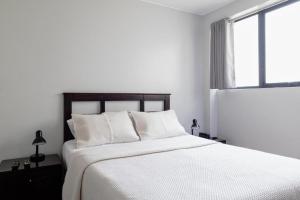 Rúm í herbergi á San Miguel Awanka Hotel