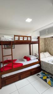 two bunk beds sitting in a room with a floor at Flat mar e sol 106 praia de porto de galinhas in Porto De Galinhas +25 photos